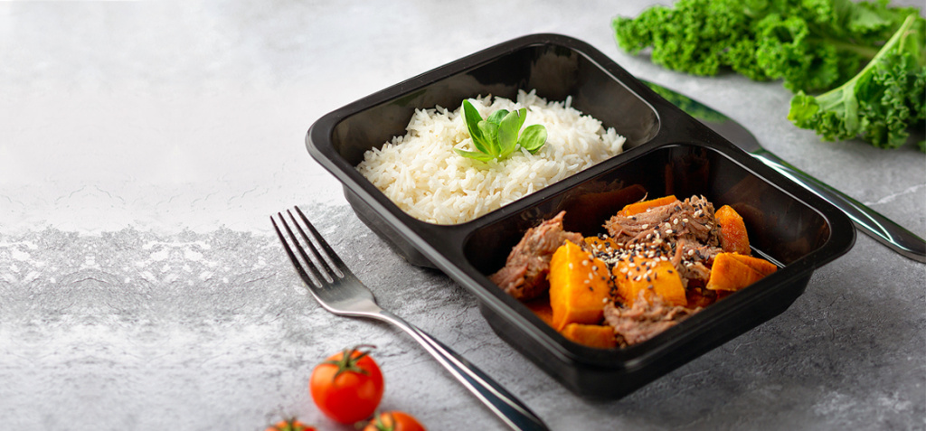 stock-photo-a-dish-in-a-black-disposable-container-from-catering-on-a-concrete-background-dietary-catering-2142903141.jpg